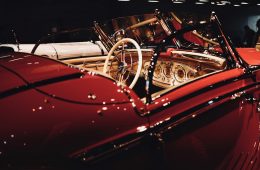 red car with black and silver steering wheel