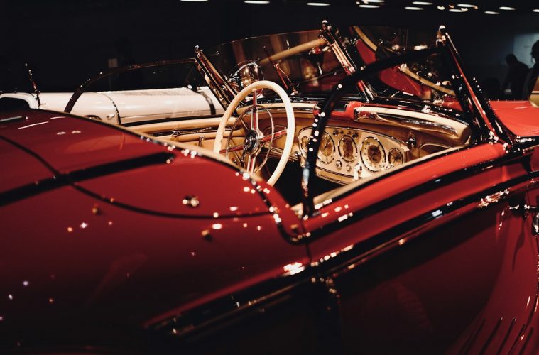 red car with black and silver steering wheel